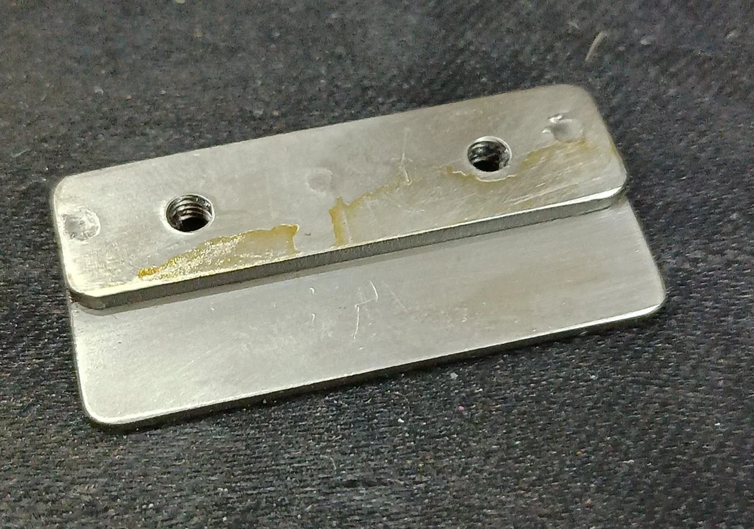 HOLDER FOR WINDER STRING UP GUIDE. 17 MM LENGTH 35 MM WIDTH 1 MM THICNESS IN BOTTAM SIDE 3 MM THICNESS IN TOP SIDE 02 THREADED HOLE IN TOP PLATE MOC SS view 1